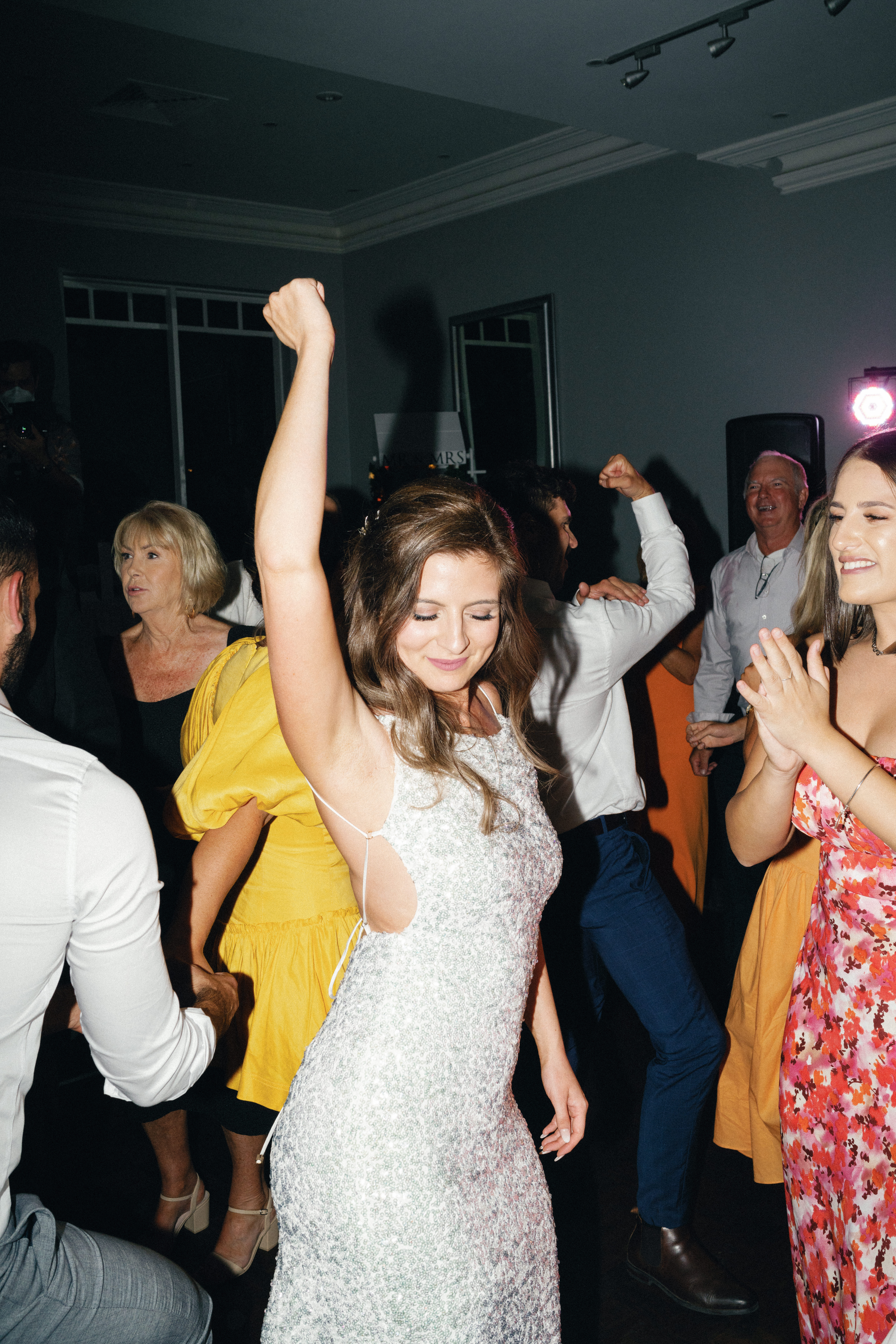 An image shot using flash of a bride partying on the dance floor.