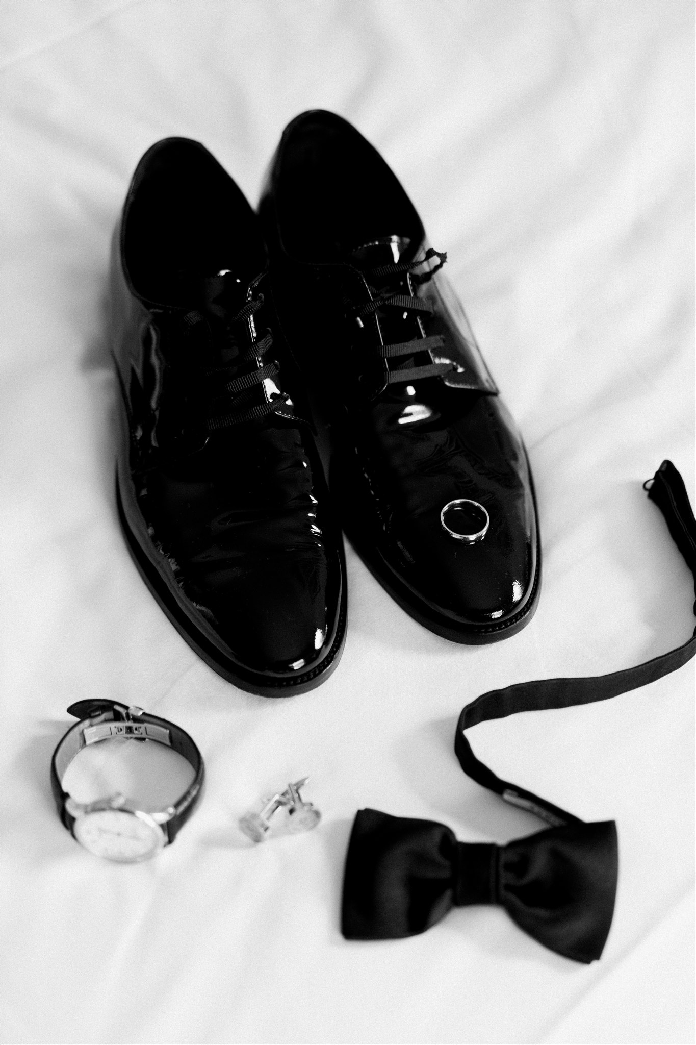 The grooms details: shoes, bowtie, watch, cufflinks