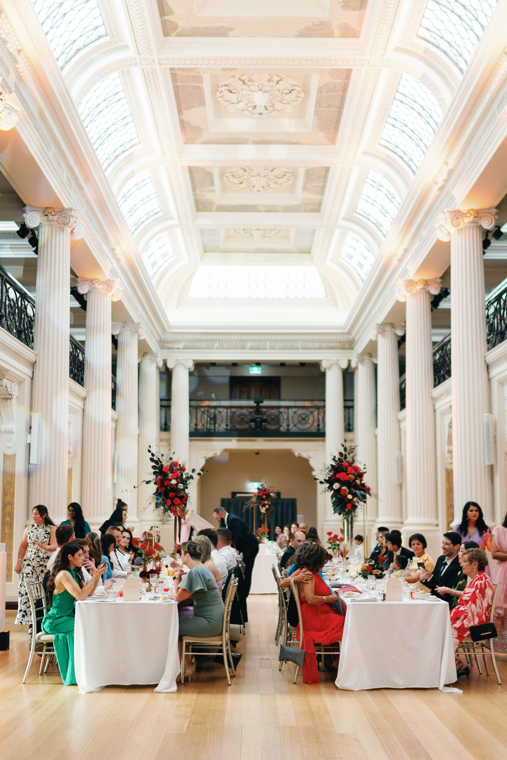 Guests being seated at a wedding reception at the State Library of Victoria