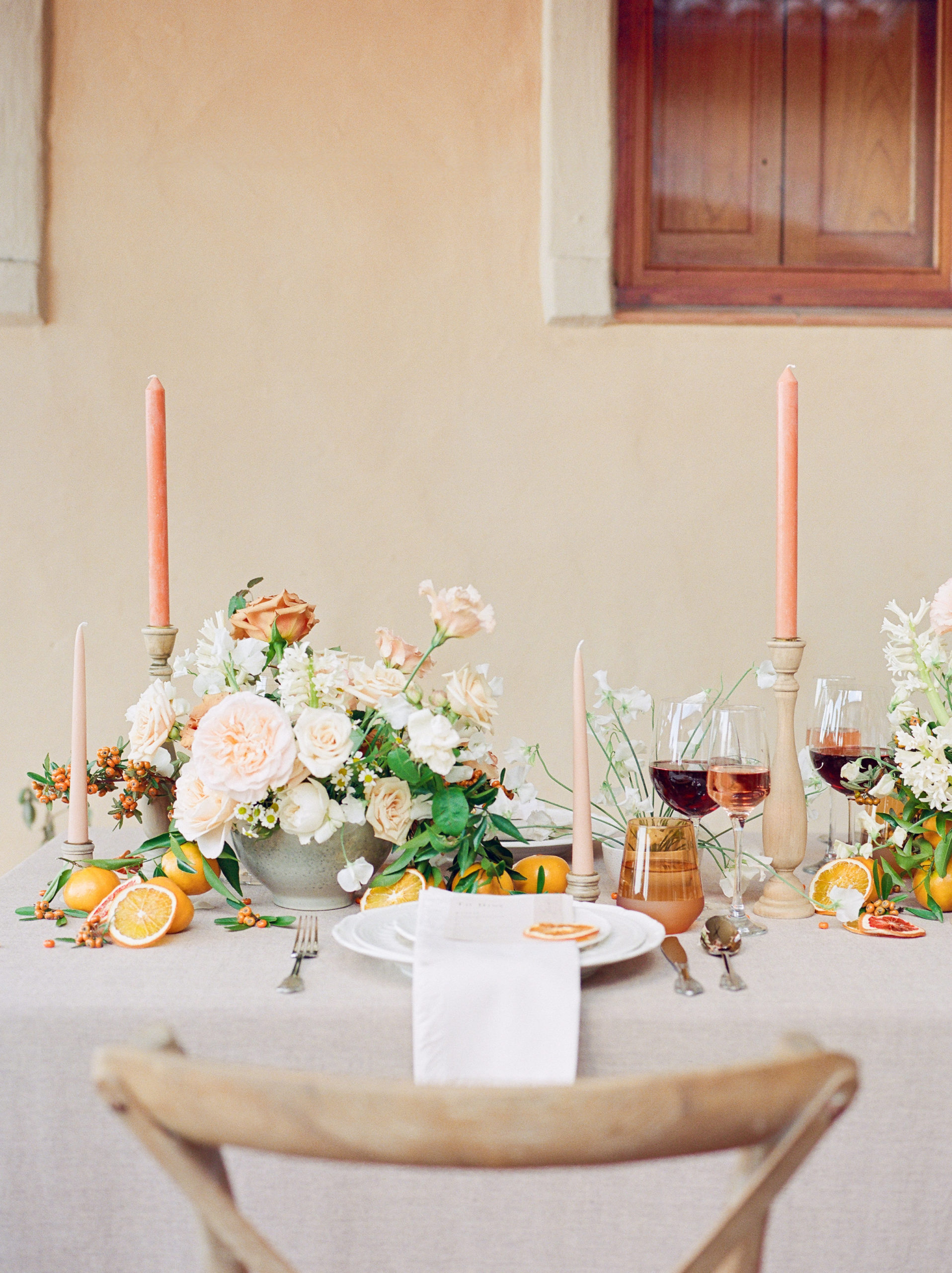 tuscan themed wedding dinner setting with warm florals
