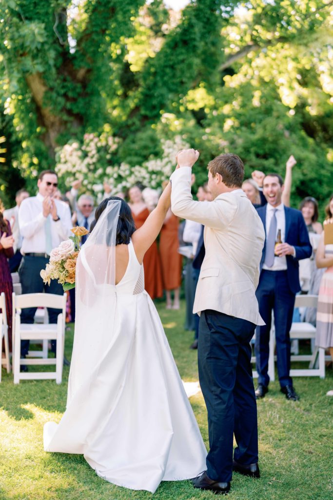 Bride and groom celebrating with a fist pump