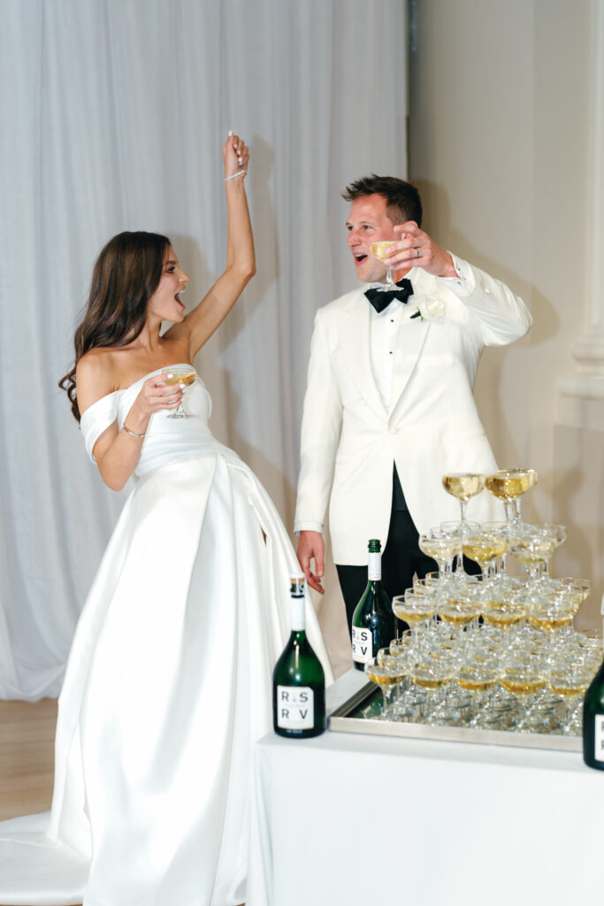 Kristen and Harry Fox toasting at the champagne tower
