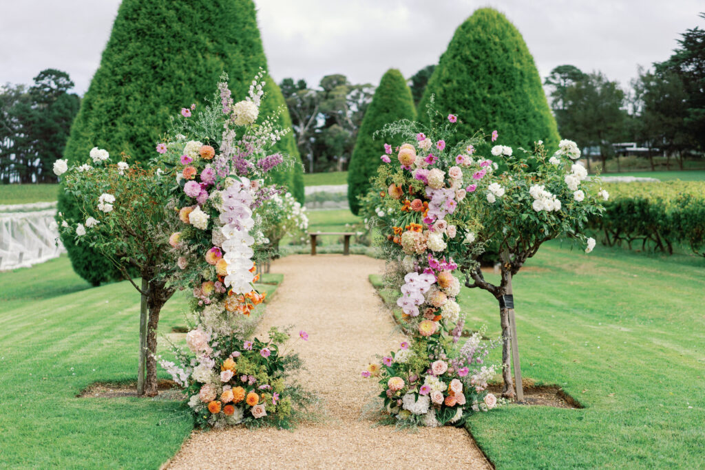 colourful wedding florals at the end of the aisle