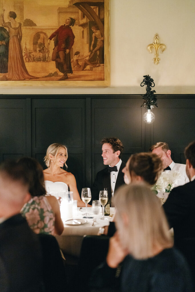 a professional wedding photographer's candid shot of a bride and groom at their reception