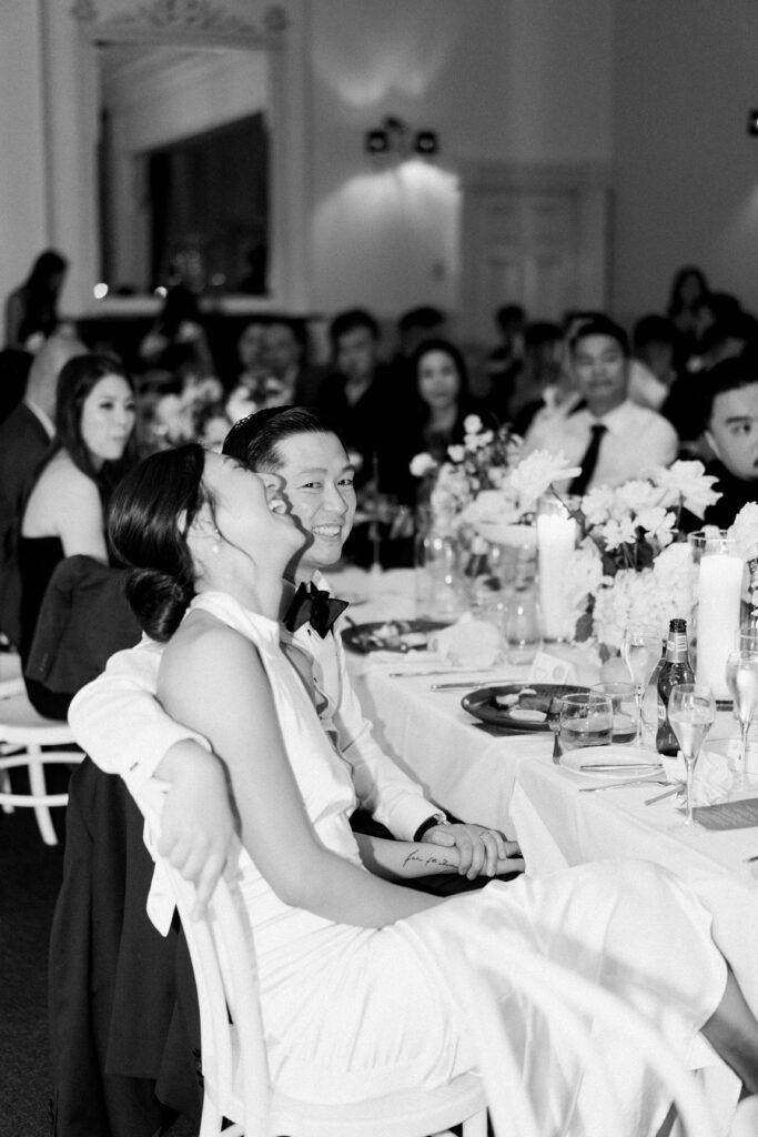 candid moment of a bride laughing during speeches