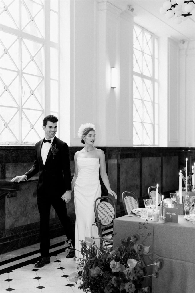 A bride and groom admire their intimate table setting in the lobby at The Trust Melbourne